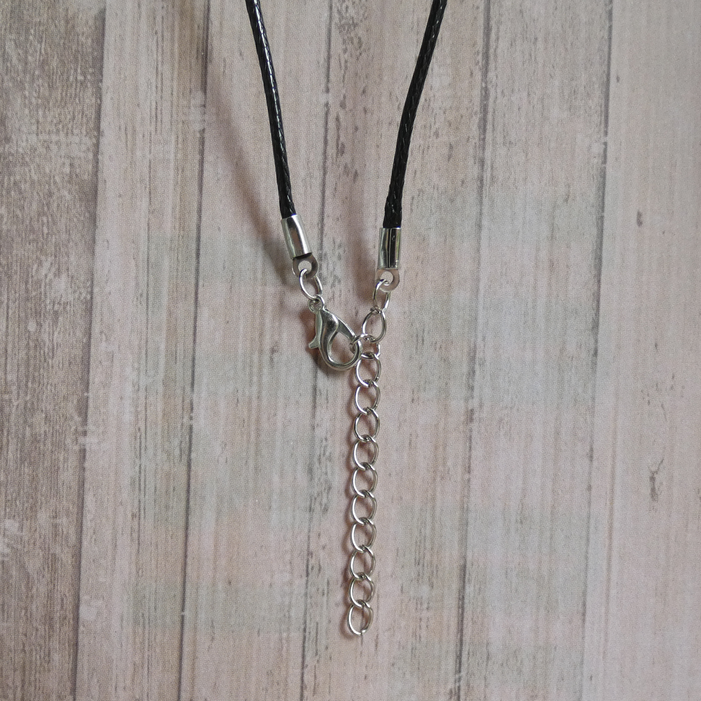 Silver and Bronze Dagger Black Cord Necklace